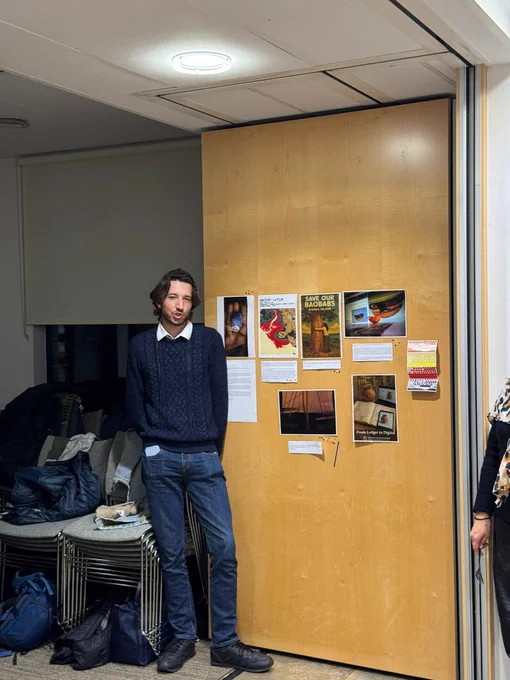 Ben Allen, standing in front of their submission for the 'Story Through an Image' for CAA-UK 2025 Cambridge 