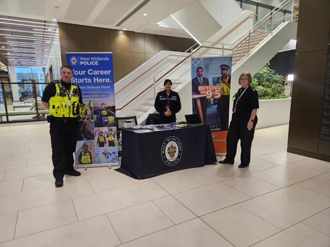 PC Begum standing with a police officer and member of staff