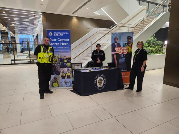 PC Begum standing with a police officer and member of staff