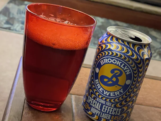 Red glass containing beer, can of Brooklyn Special Effects