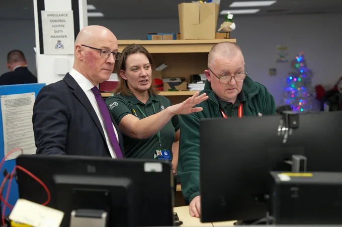 First Minister John Swinney with NHS 24 and Scottish Ambulance Service staff at Caledonia House, Glasgow.