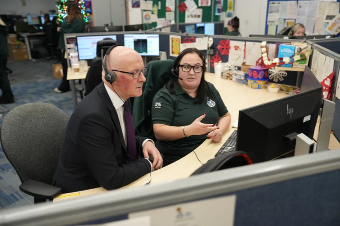 First Minister John Swinney with NHS 24 and Scottish Ambulance Service staff at Caledonia House, Glasgow.