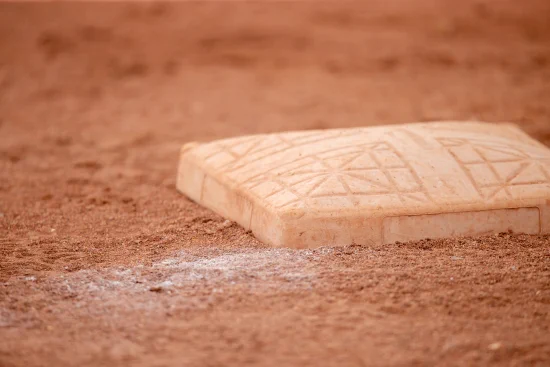 A softball base on dirt