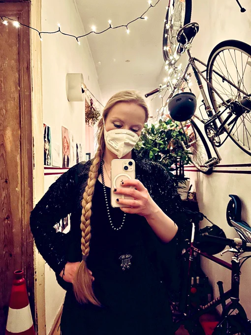 Festive Thirst Masker posing in a festive Berlin style hallway.