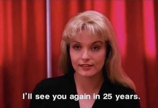An image of a woman looking towards the camera and saying 'I'll see you again in 25 years'.
