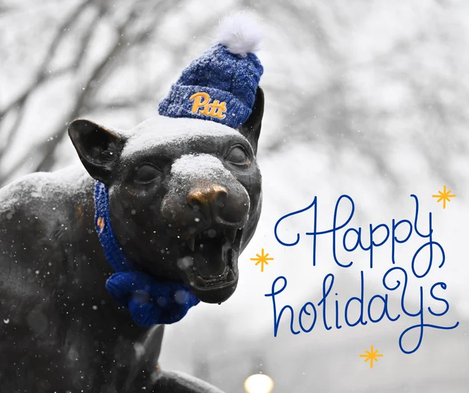 A panther statue wearing a blue and yellow beanie and scarf. Text overlay reads Happy Holidays.