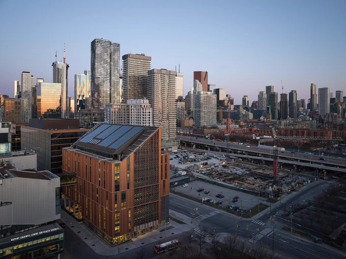View of Toronto skyline at dusk featuring modern buildings and busy highways.