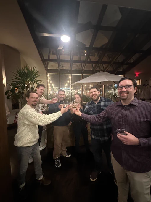 Bytes.co team members raising their glasses together for a toast