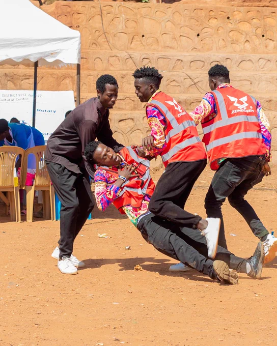 First aid responders from Rotary helping an individual during a training exercise outdoors.