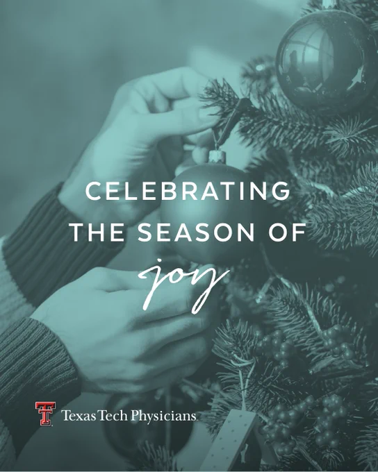 A set of hands putting an ornament on a douglas fir tree with the words “CELEBRATING JOY THIS HOLIDAY SEASON OF JOY”. 