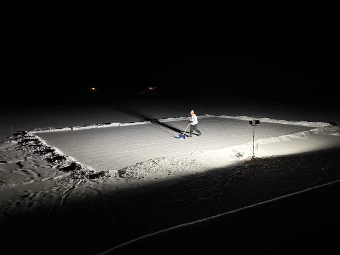 Son clearing the lake for a hockey rink