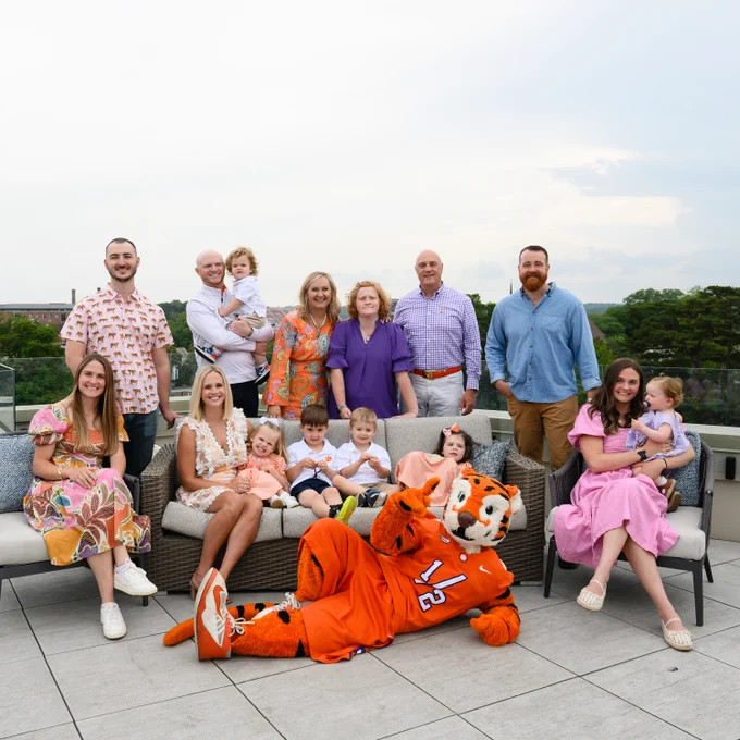 The Clements Family gathered for a photo on a rooftop, with the Clemson Tiger mascot included.