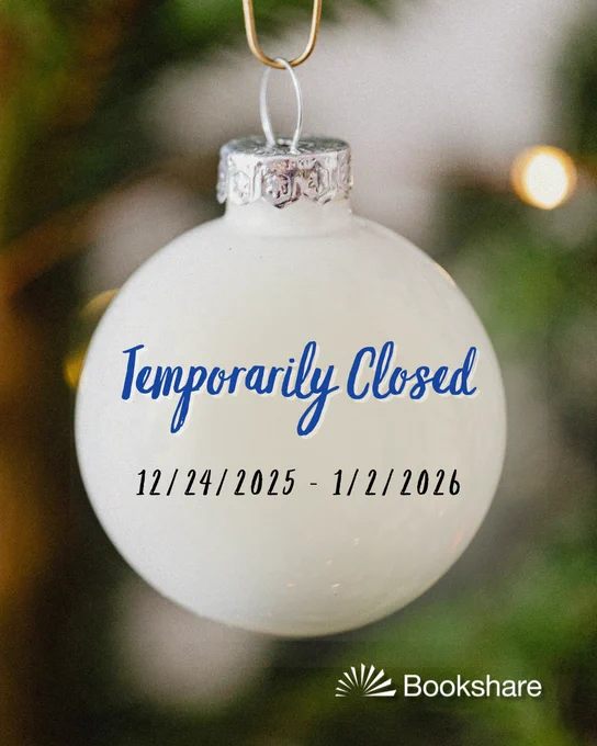 A close-up photograph of a white Christmas ornament hanging from a tree.