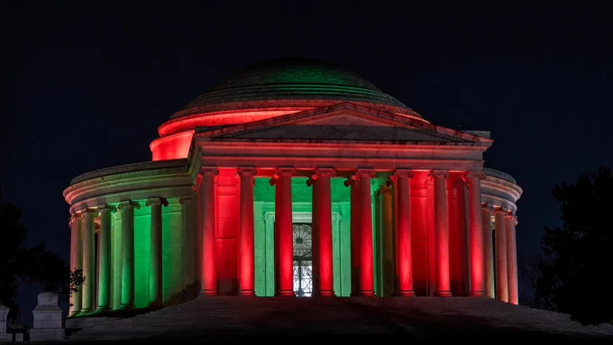 The Jefferson Memorial lit up in red and green.