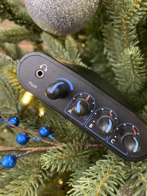 A Switch Back M8RX nestled in the branches of a lit and decorated Christmas tree.