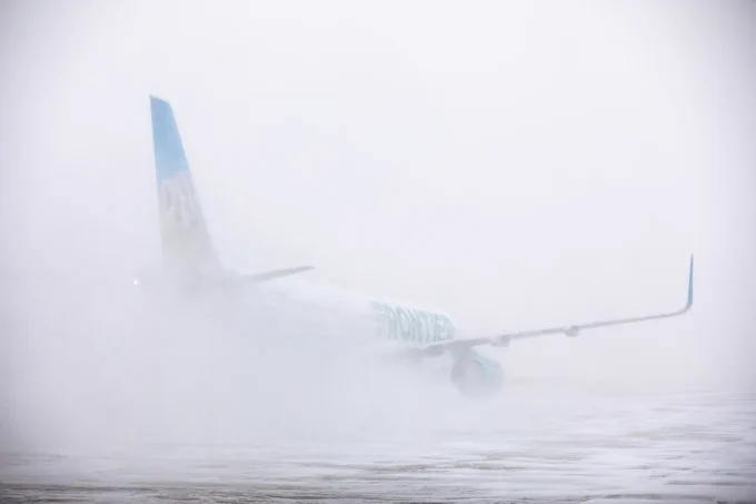 A plane on a snowy runway. Photograph provided courtesy of Denver International Airport.