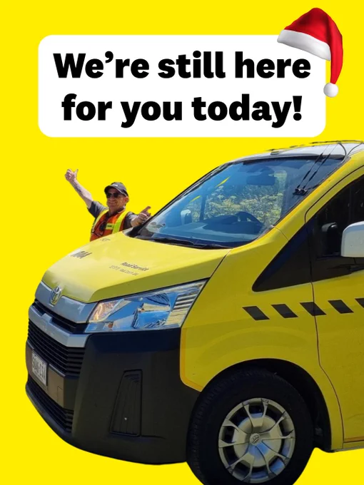 A person in a safety vest waving next to a yellow RAA van with the text "We're still here for you today!" displayed above, including a Santa Claus hat on the first word.