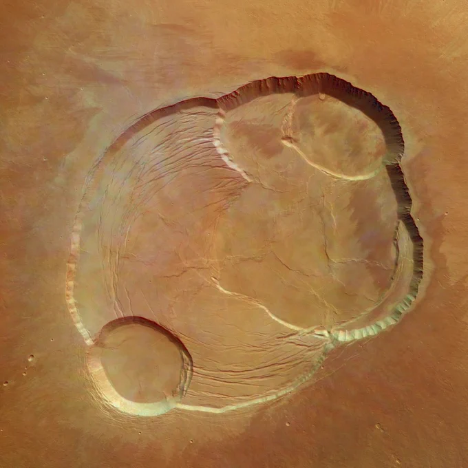 The caldera of Olympus Mons on Mars looks very similar to the caldera on Kilauea, with many circular depressions and concentric fractures. It's just a whole lot bigger: ~50 mi (80 km) across! ESA/DLR/FU Berlin