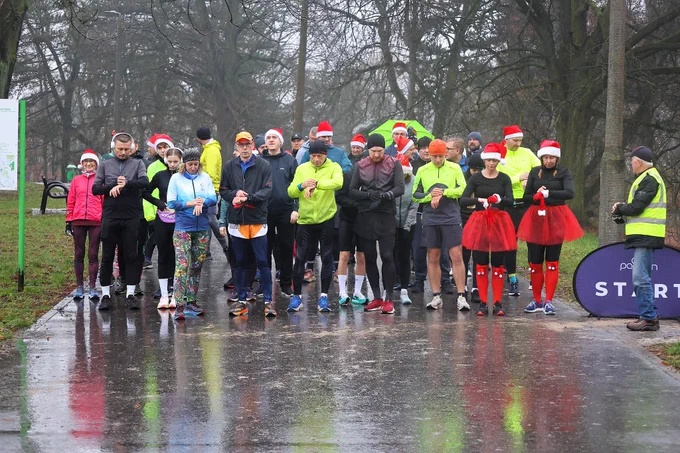 A group of parkrunners in Poland wearing Santa hats ready to start a parkrun. 