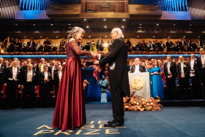 Mary receiving her medal and certificate