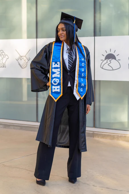 An Angelo State Housing Student Staff member posing for graduation.