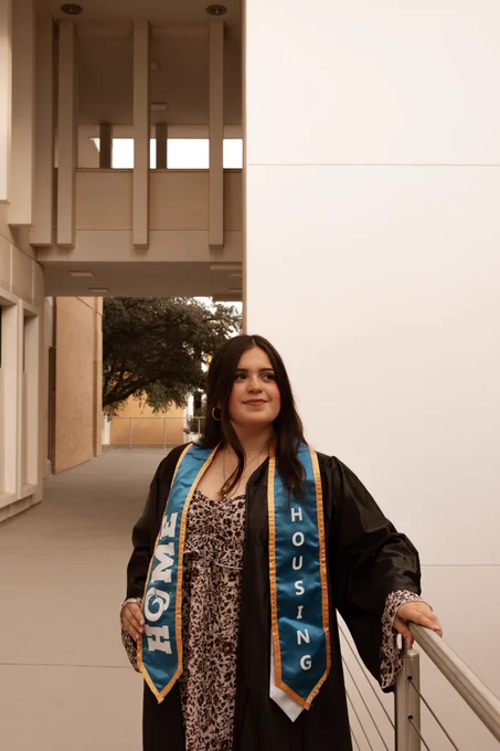An Angelo State Housing Student Staff member posing for graduation.