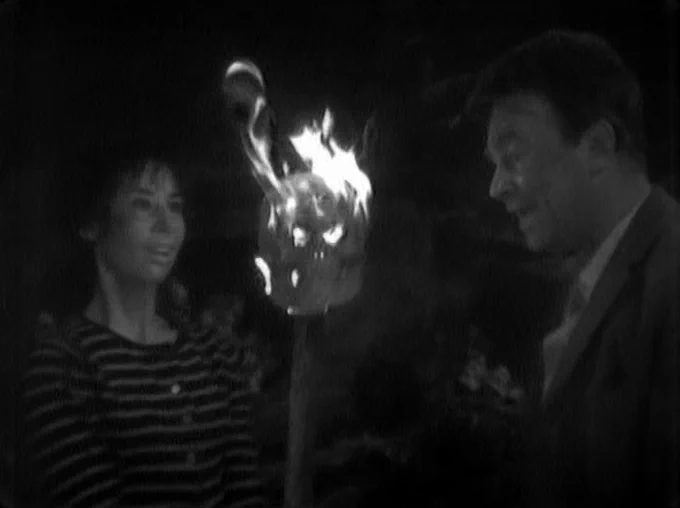 Susan delights in a flaming skull on a stick! Kids had no candy floss in 100,000BC