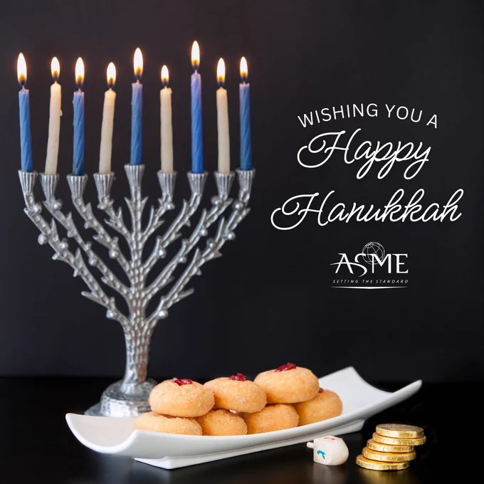 A menorah with lit candles, accompanied by a plate of sufganiyot, a dreidel and chocolate coins, against a dark background with a greeting "Wishing you a Happy Hanukkah" and the ASME logo.
