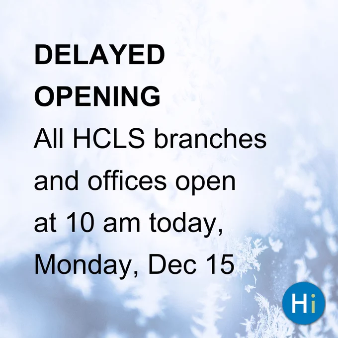 Notice of delayed opening for all HCLS branches and offices, stating they will open at 10 am on Monday, Dec 15, set against a background of frosty tree branches.