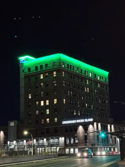 A building in downtown Providence is lit green for Injury Prevention Day.