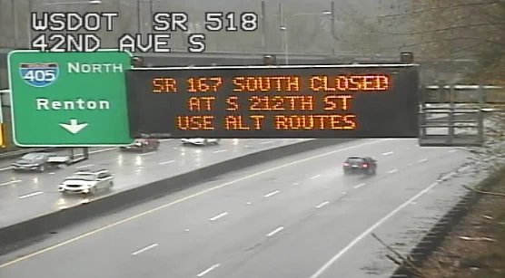 A daytime image showing an electronic overhead highway sign announcing that southbound SR 167 has closed at S 212th Street. 