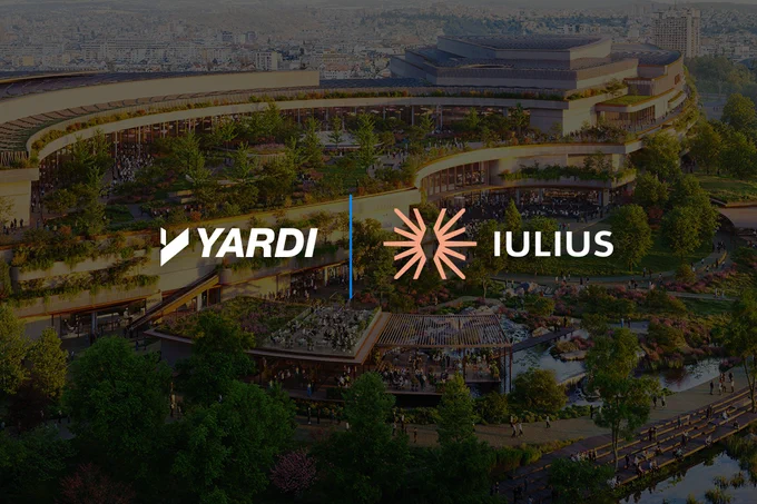 Aerial view of a modern commercial complex with prominent logos of Yardi and Iulius displayed.