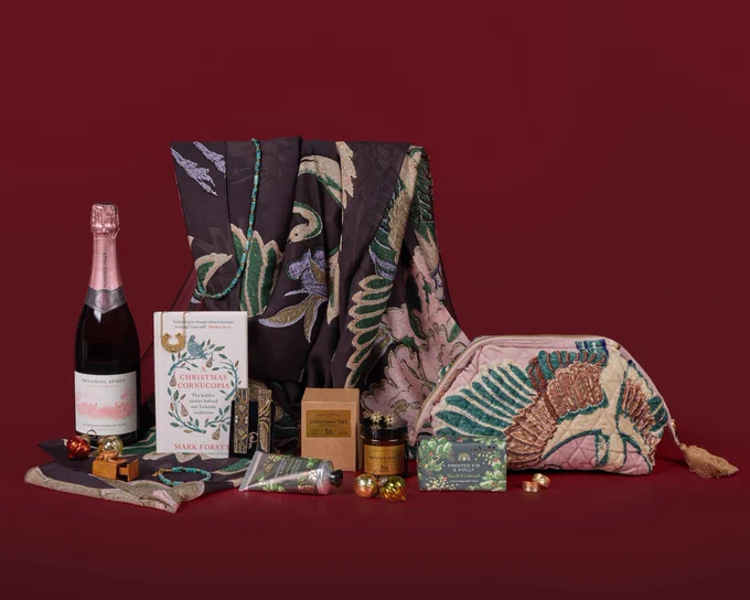 An array of shop products set against a deep red background

