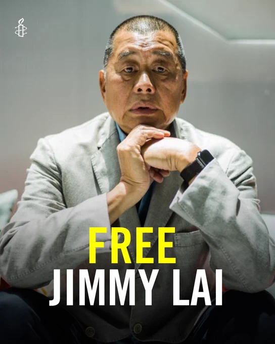 Picture of Jimmy Lai sitting with "Free Jimmy Lai" written.