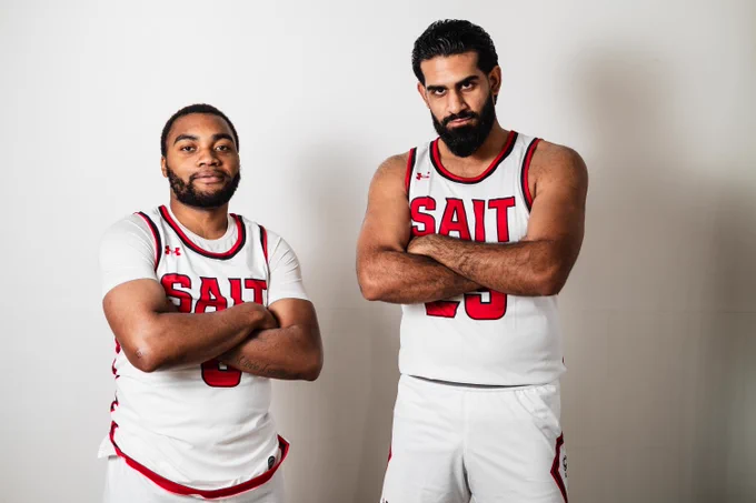 Two basketball players posing. 