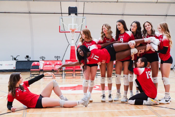 The SAIT women's volleyball team posing as the iconic Michelangelo Sistine Chapel Painting. 