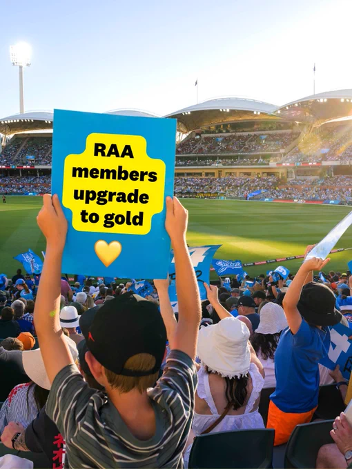 Audience members holding signs and cheering at a cricket match at Adelaide Oval, with one sign promoting an RAA membership upgrade.