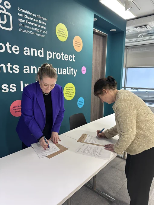 Photo of Deirdre Malone and Dr Aideen Hartney signing documents