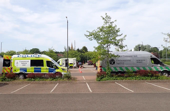 Environment Agency van and Police van parked in a car park. 