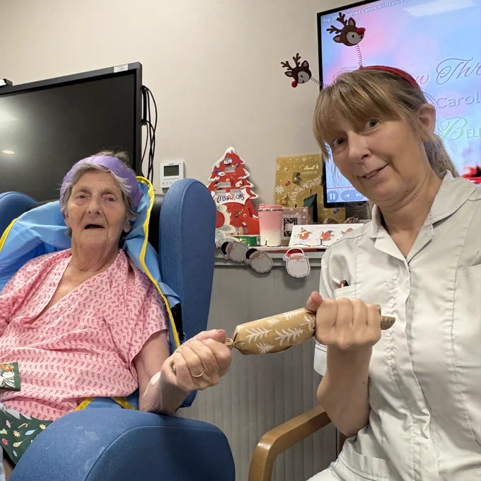 Patient and therapist pulling a Christmas cracker.