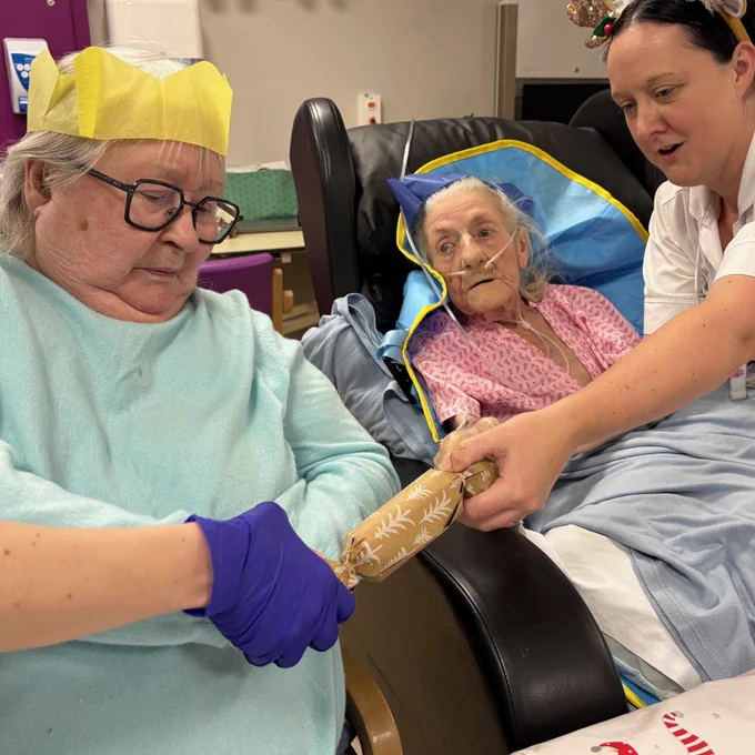 Patient and therapist pulling a Christmas cracker.