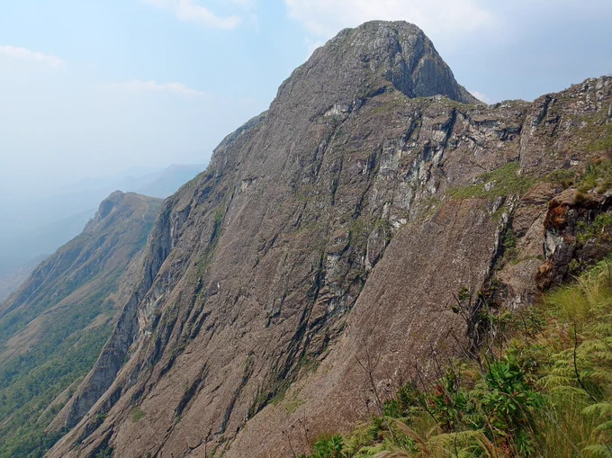 Image of rocky mountain peak from below