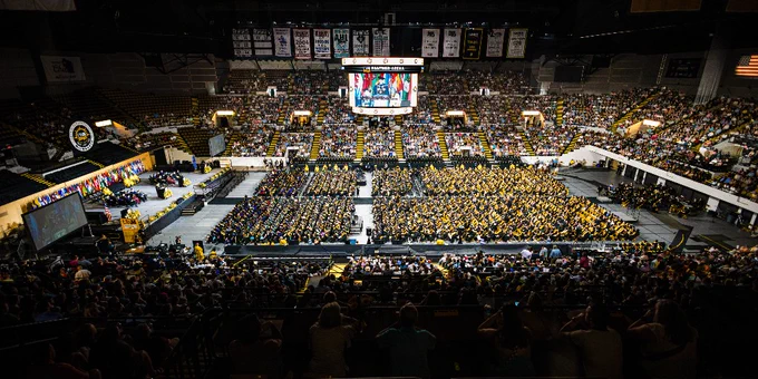 UW-Milwaukee Panther Arena filled with graduates and their supporters at a UWM commencement ceremony.