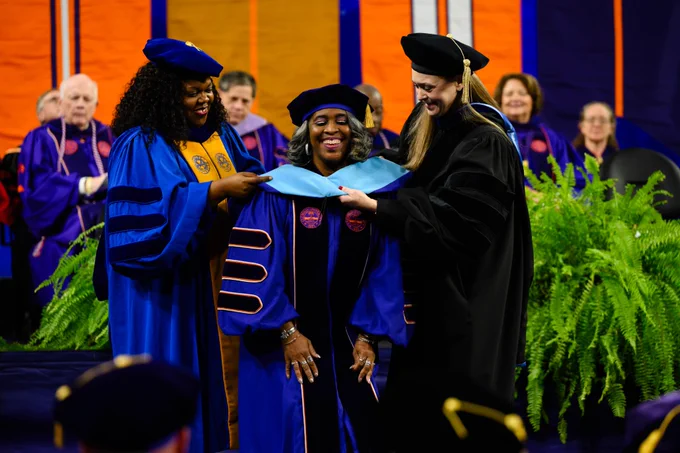 A person being hooded at graduation.