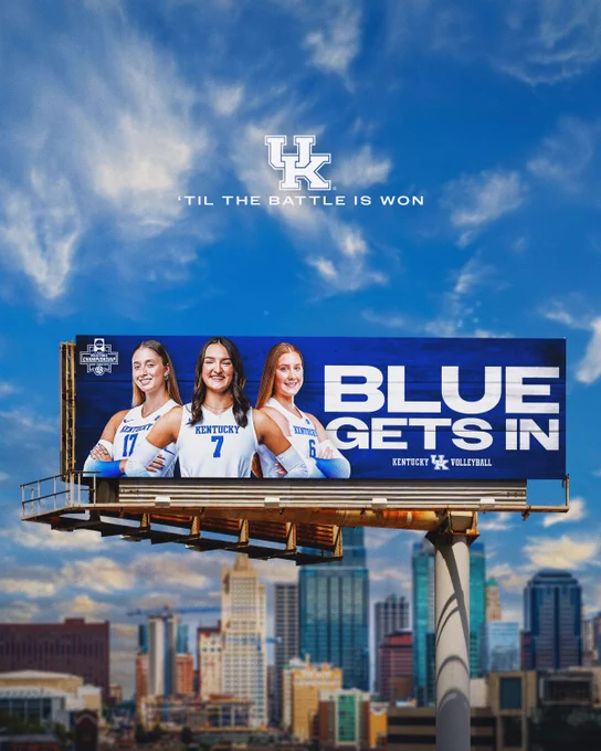 A Kentucky Volleyball billboard in front of the Kansas City skyline.