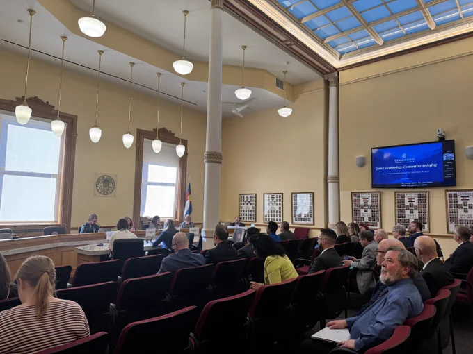 The gallery in the Joint Technology Committee room, Chancellor DeSanctis is presenting. 