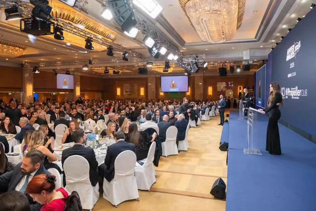 Ambassador Guilfoyle standing at the podium and delivering remarks at the Amver Awards Ceremony attendees.