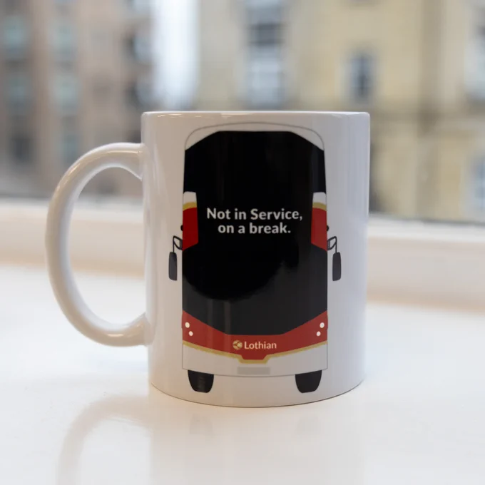 White mug featuring a red and black bus design with the message 'Not in Service, on a break.' and the Lothian logo below.