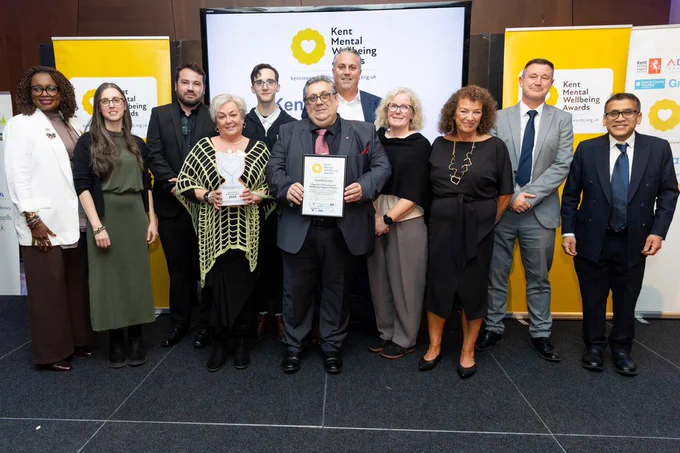 Eight staff from Town & Country Housing are stood smiling with Dr Blessing Enakimio, Southeastern's Lee Woolcott-Ellis, and our VIP speaker Dr Kush Kanodia
