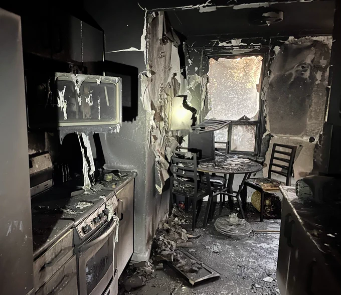 The remains of a kitchen post fire incident. The entire room and contents are severely damaged by the fire.